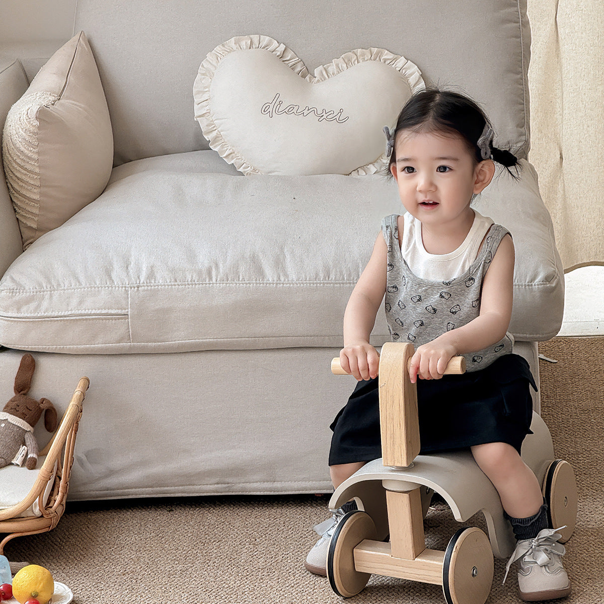 A set of a gray Kitty-themed vest and a black utility-style short skirt for little girls