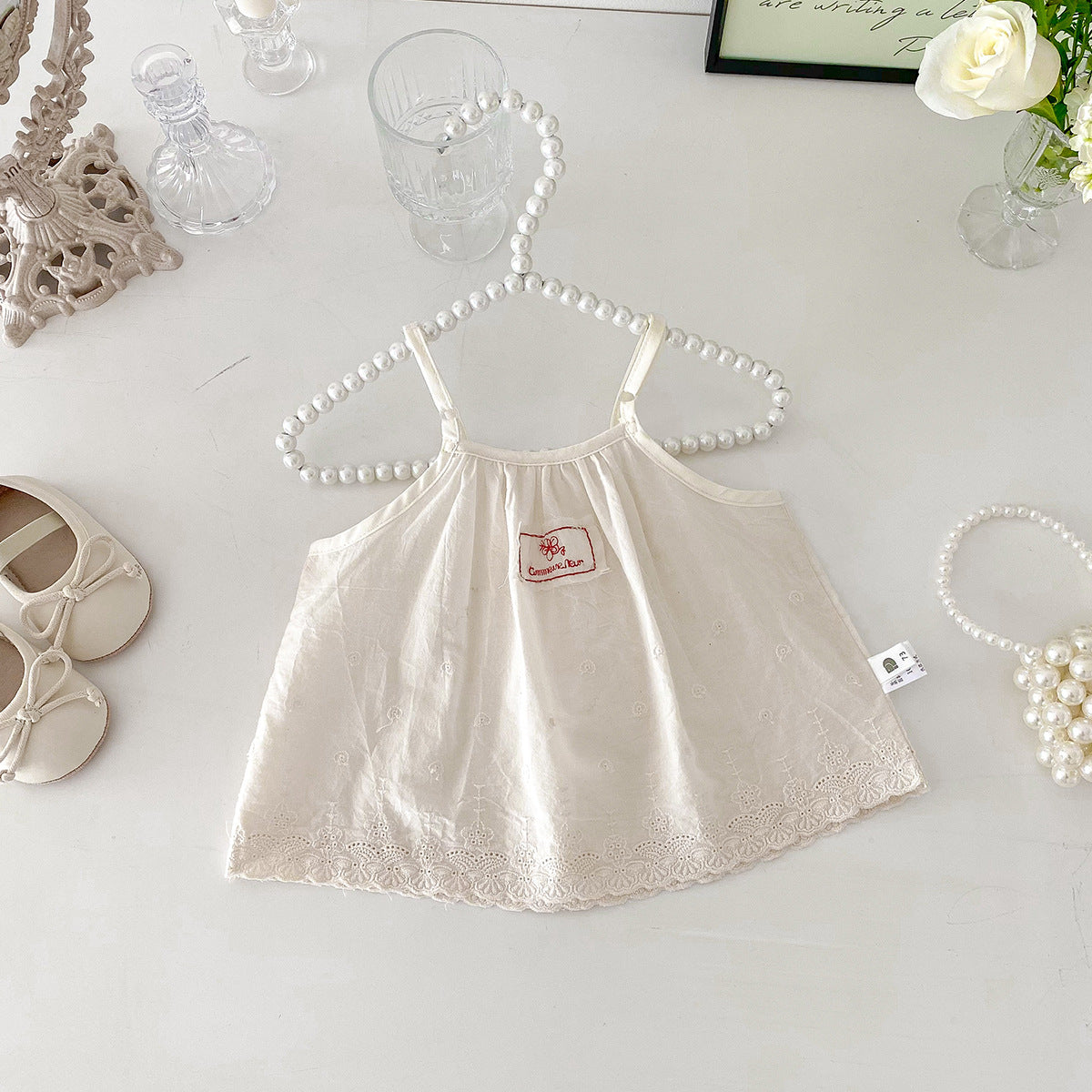 A set of an apricot-colored doll-style blouse and polka-dot shorts for little girls